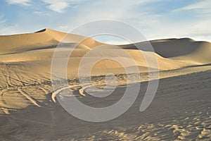 Off road vehicle tracks in sand at Imperial Sand Dunes, California, USA