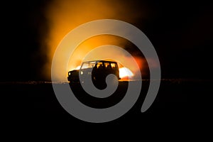 Off roader jeep silhouette on dark toned foggy sky background. Car with light at night