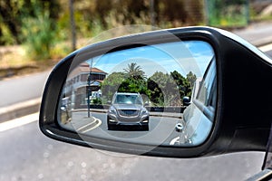 Off-roader seen in the rearview mirror of the car