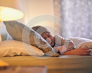 Off to dreamland. Shot of a cute little girl sleeping alone in her bed.