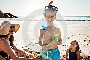 Off to hunt for seaside treasures. an adorable little boy wearing snorkelling goggles on a fun day with family at the