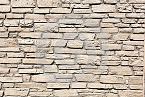 Off white brick stone wall, different size bricks