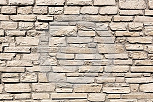 Off white brick stone wall, different size bricks