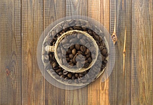 Ð¡offee beans and a cup on a wooden background. Coffe cup with copy space for text.