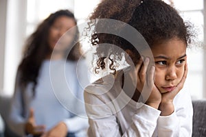 Offended African American preschooler girl looking in distance photo