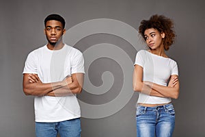 Offended black man and woman standing separately