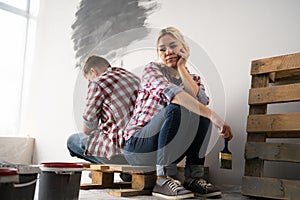 Offended couple has conflict planning painting walls and interior in new house