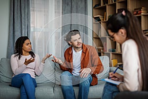 Offended dissatisfied angry emotional millennial different husband and wife swear at meeting with psychologist