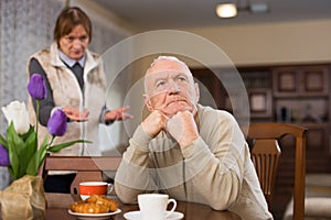 Offended elderly man with angry wife