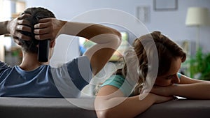 Offended girl sitting by boyfriend watching football match tv, relations crisis