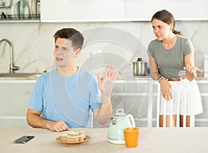 Offended guy making dismissive stopping gesture while girlfriend swearing