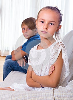 Offended little girl and teenager indoors