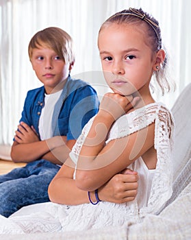 Offended little girl and teenager indoors