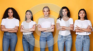 Offended Multiracial Females Group Crossing Hands Posing On Yellow Background