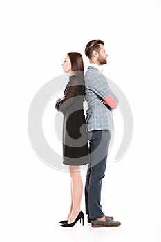 Offended serious loving couple standing isolated