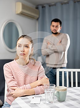 Offended woman sitting at home after spat with boyfriend