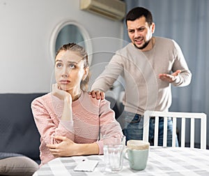 Offended woman sitting at home after spat with boyfriend
