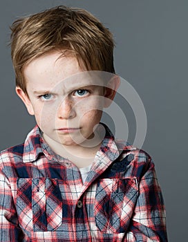 Offended young child sulking and pouting expressing kid anger