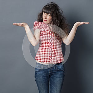 Offended young woman displaying hands to compare equal confusing choice