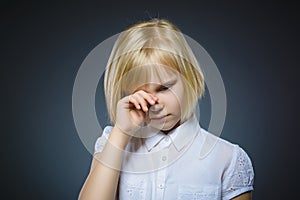 Offense crying girl on gray background