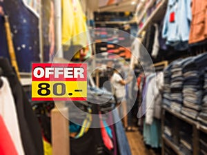 `Offer 80 THB` sign clothing store with blurred effect, at Thailand