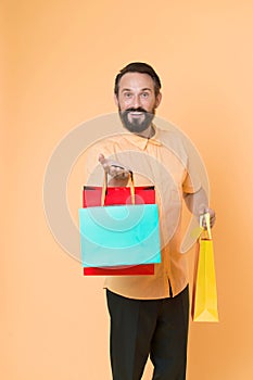 Offer bonus for client good idea. Man mature bearded cheerful face holds shopping bags. Man got unexpectable gifts. Guy
