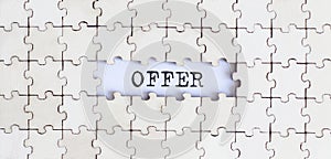 OFFER .Business concept. White puzzle pieces with different phrases on the white background, top view