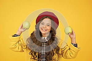 Offering healthy food in school. Happy child hold apples yellow background. Healthy school snack. Dieting plan for
