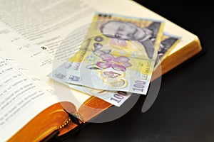 Offering romanian currency and holy bible photo