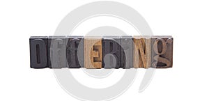 OFFERING spelled in wooden block letters photo