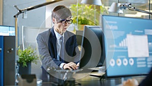 In the Office Agitated Businessman works on a Desktop Personal C