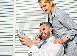 Office assistant gives massage boss help relax. Man successful businessman phone conversation while assistant do