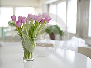 Office background. Valentine\'s Day home. Tulip bouquet in a Scandinavian interior. Spring decoration background