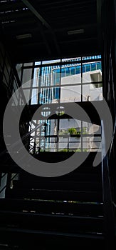 office building as seen from indoor space and silhouette of stairs