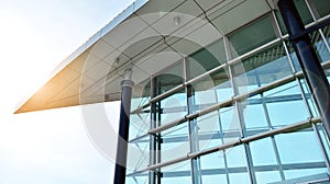 Office building, details of blue glass wall and sun reflections.