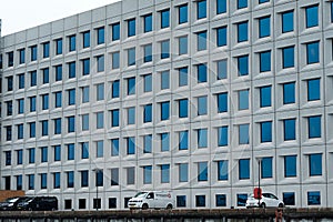 an office building with lots of windows and a large clock on the front