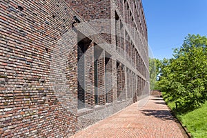 Office building made of brick with large Windows. Decorative masonry using curves, non-standard bricks.