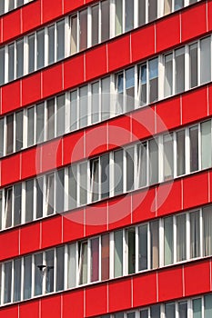 Office building with red faÃ§ade and tiltable windows  .