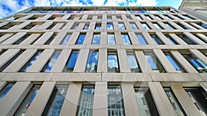 Office building reflecting blue sky