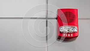 An office building\'s fire alarm switch is mounted on the wall