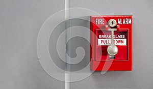 An office building\'s fire alarm switch is mounted on the wall