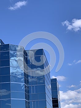 Office building under blue sky and white clouds