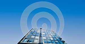 Office building under clear blue sky for text space