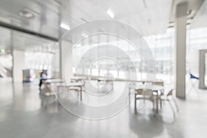 Office building or university lobby hall blur background with blurry school hallway corridor interior view toward empty corridor