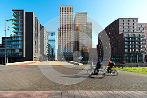 Office buildings in Amsterdam Zuid, Amsterdam, Netherlands. People bicycling in Amsterdam, Netherlands. photo