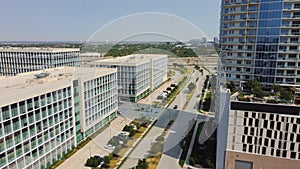 Office buildings and modern condominium tower surrounding by multistory apartment building, modern villas, in downtown Plano,