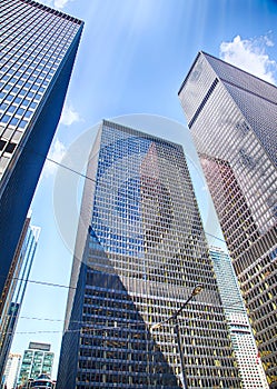 Office buildings stretch up to the blue sky in the financial district in downtown Toronto, Canada