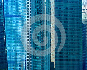 Office buildings windows. Blue glass architecture facade design with reflection of sky in urban city, Downtown Singapore City in