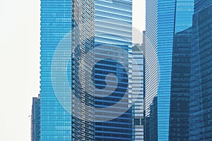 Office buildings windows. Blue glass architecture facade design with reflection of sky in urban city, Downtown Singapore City in