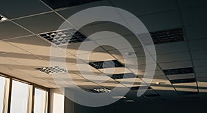 office ceiling with recessed lights and sunlight